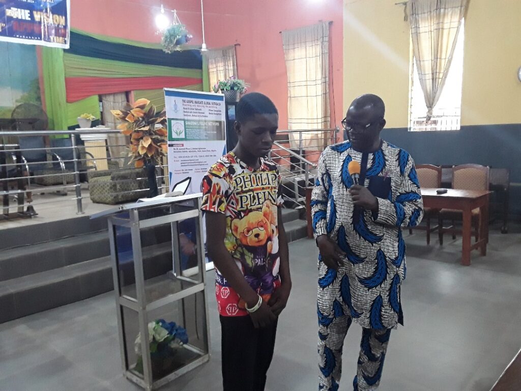 Rev Dr. John Owoeye with one of the youth attendees of the Odo Ponyan Outreach